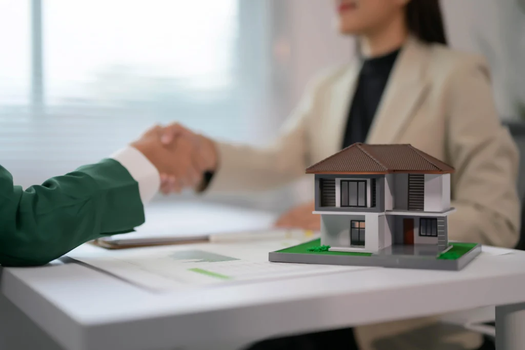 real estate agent shaking hands with client over h 2025 01 10 13 33 28 utc min scaled